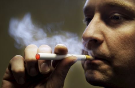 epa01217666 A customer uses a device called 'supersmoker', made available to the Dutch market ahead of the smoking ban for cafes and restaurants from the first of June in the Netherlands, 09 January 2008 in Delft. Sales of the fake cigarette have increased considerably from the beginning of January, with the brand expecting to have soid 200.000 by the end of the month, as opposed to the 120.000 sold last year since it's introduction. Supersmoker, an electronic cigarette, is made of synthetic material and works with nicotine cartridges that are placed into the device. The user can regulate the strength of the nicotine and as the smoker inhales, the end of the cigarette lights up and what appears to be a plume of smoke is released. EPA/ROBIN UTRECHT