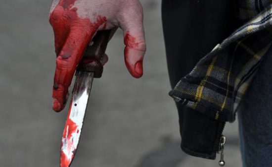 TORONTO, CANADA: A reenactment scene of a hand holding a bloody knife. (Photo credit © Ted Overton / Wall To Wall Media Ltd )