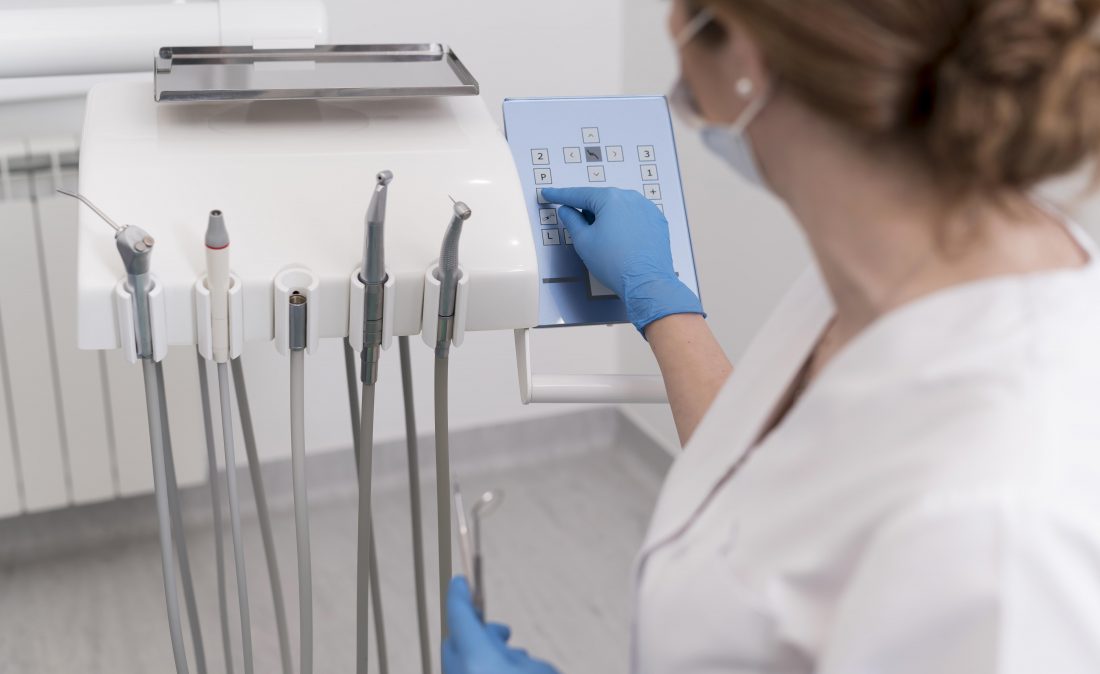 female-orthodontist-with-latex-gloves-handling-dental-equipment