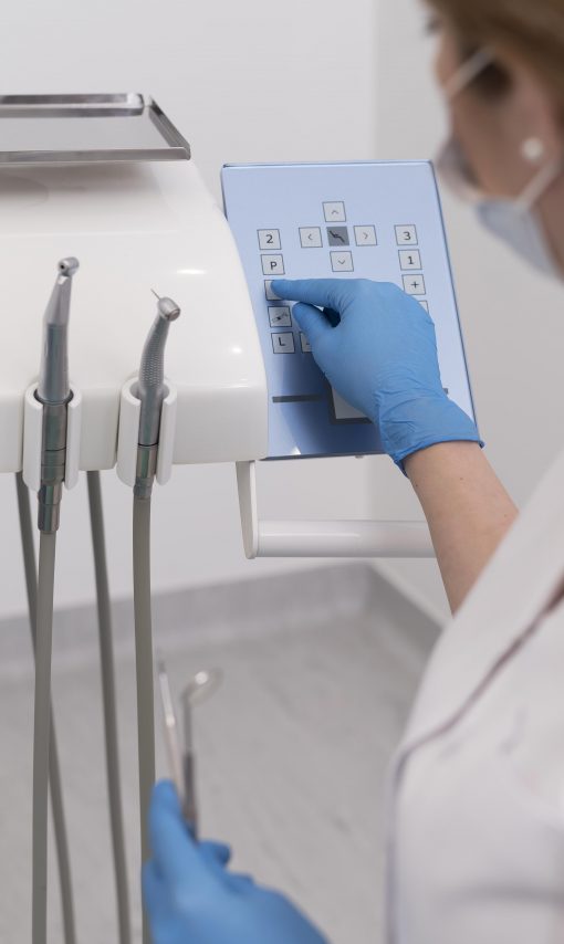 female-orthodontist-with-latex-gloves-handling-dental-equipment