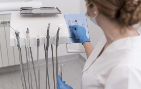 female-orthodontist-with-latex-gloves-handling-dental-equipment