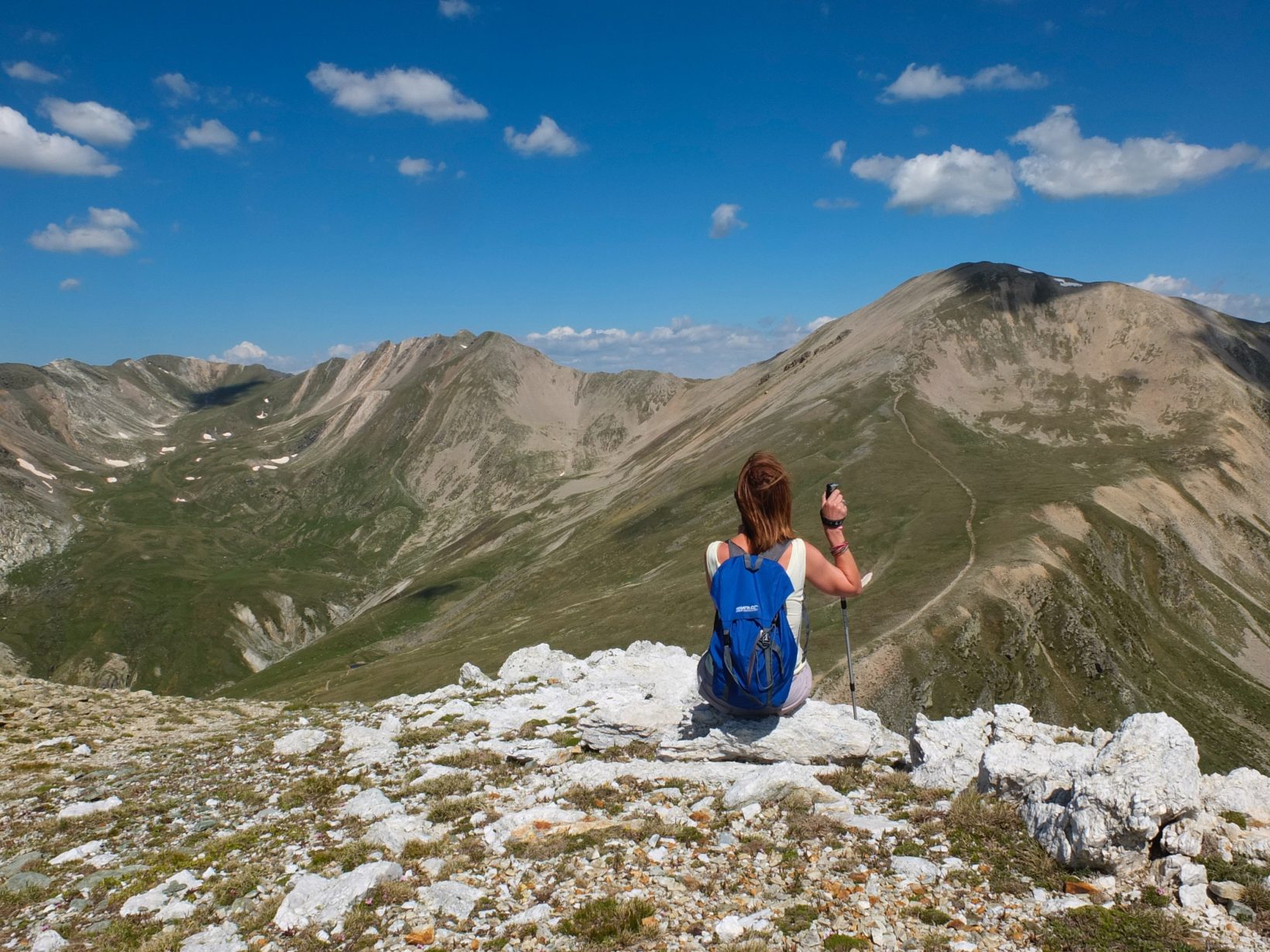 friends-standing-on-mountain-against-blue-sky-249605