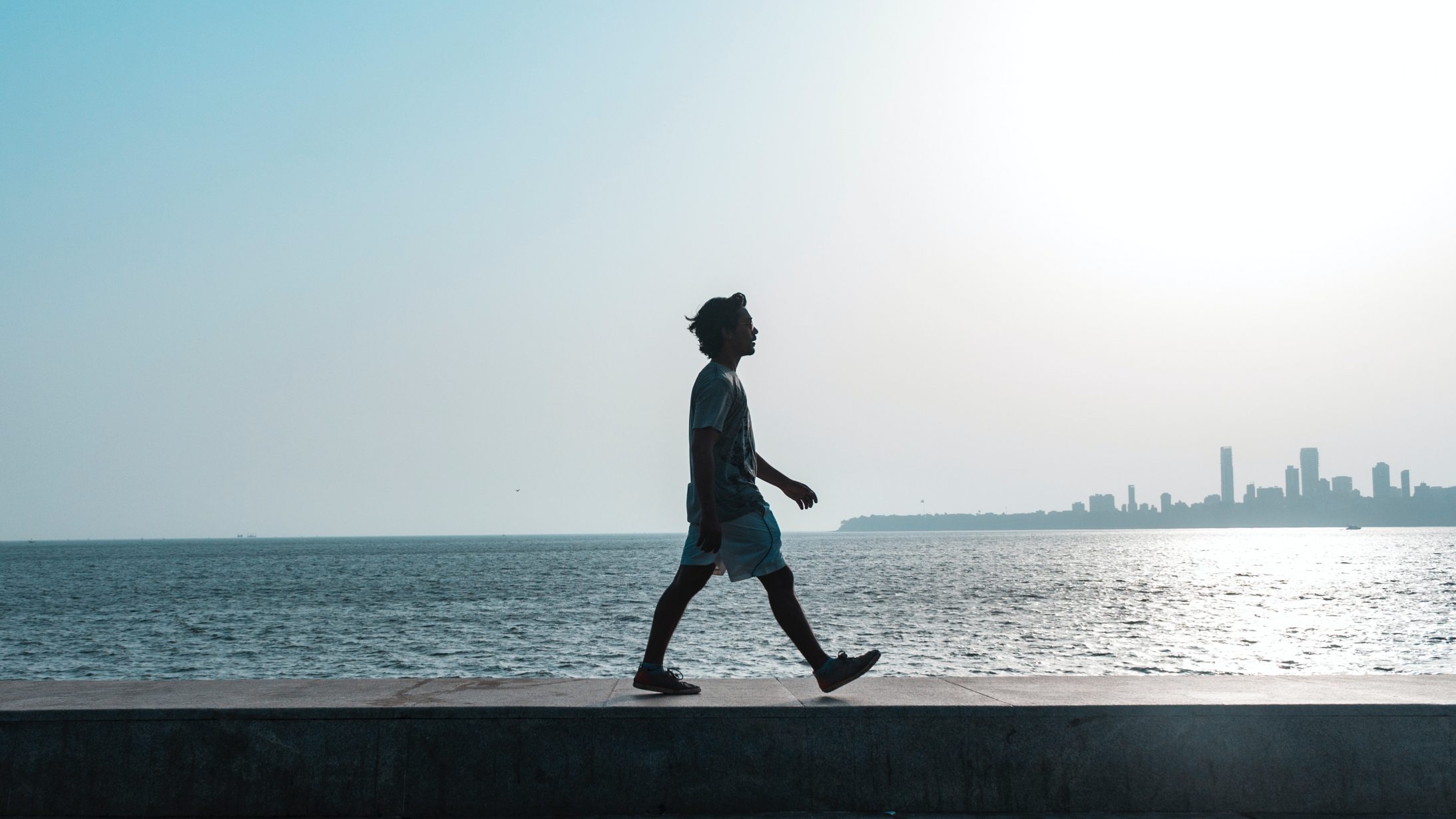 man-walking-near-body-of-water-1466852