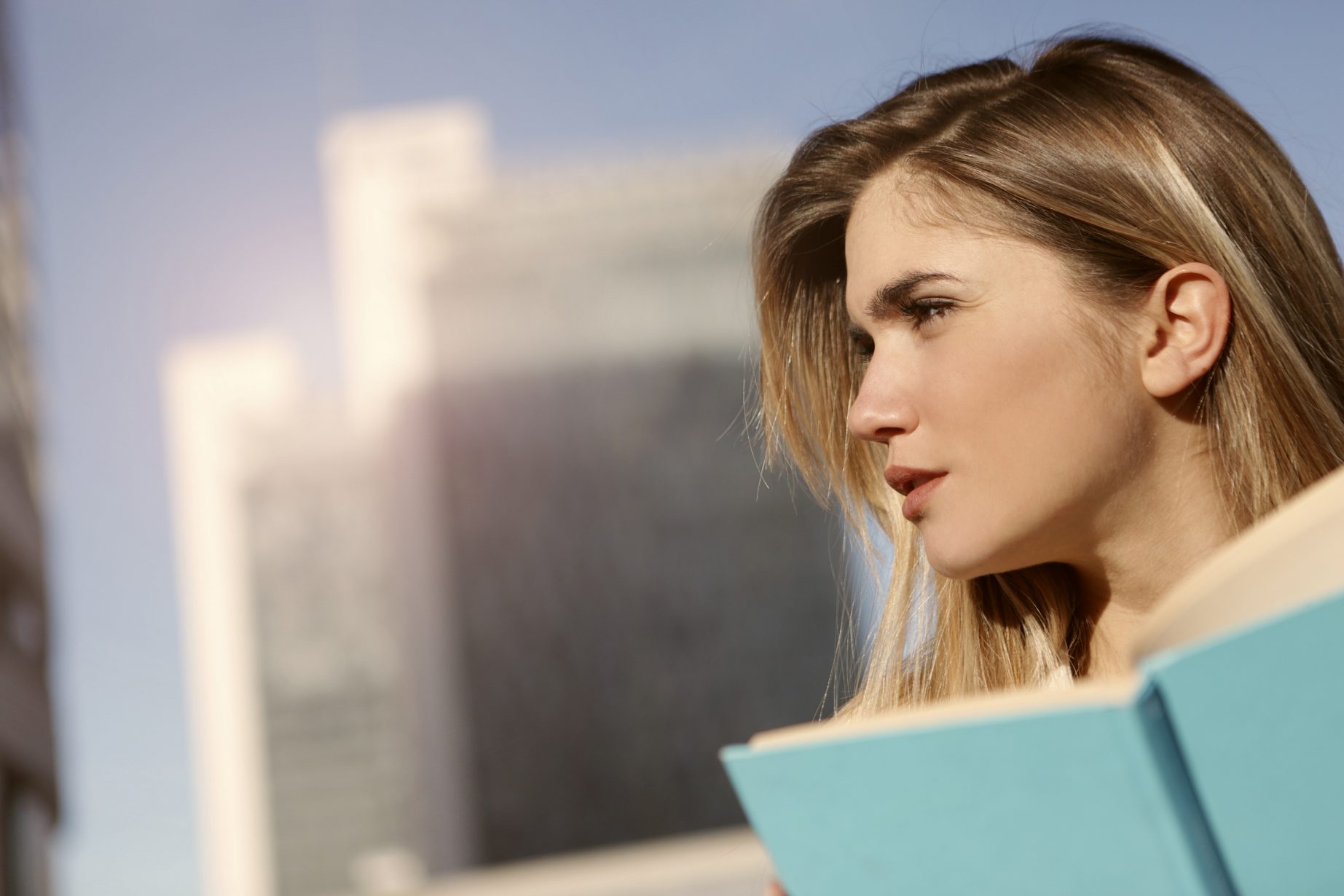 side-view-photo-of-a-woman-holding-blue-book-3781537